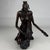 A striking and evocative 19th-century European bronze sculpture depicting an African mother carrying her young child upon...