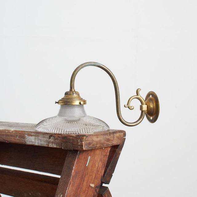 An antique glass prismatic wall light. The light has retained its original brass wall bracket, which has some great age...