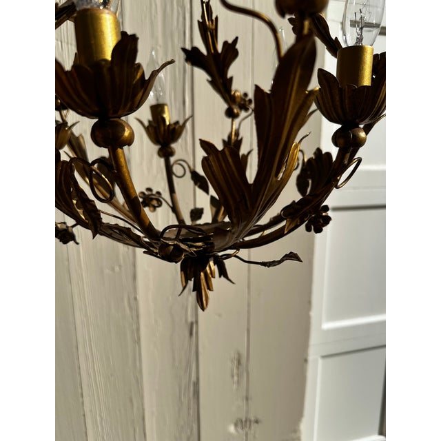Old Lights On is pleased to offer this charming vintage four arm Hollywood Regency floral chandelier. It is wired and...