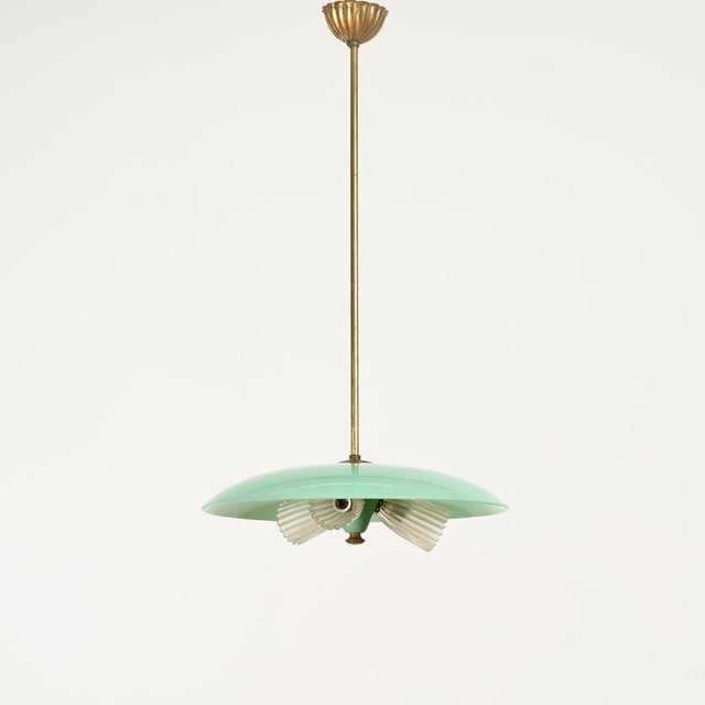 Spectacular italian mid-century chandelier in a stunning combination of turquoise glass, brass, and murano glass. This...