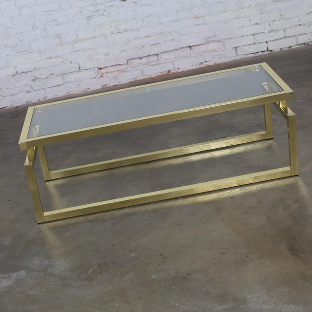 Fantastic vintage Modern coffee or cocktail table composed of a rectangular brass toned anodized aluminum frame with...