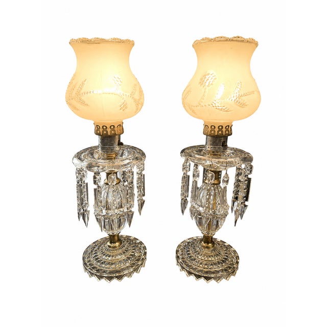 A charming pair of vintage 1950s Hollywood Regency boudoir lamps featuring beautifully molded crystal-style bases,...