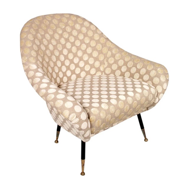 This Mid-Century lounge chair is attributed to Gio Ponti. It was recently reupholstered and features golden brass legs....