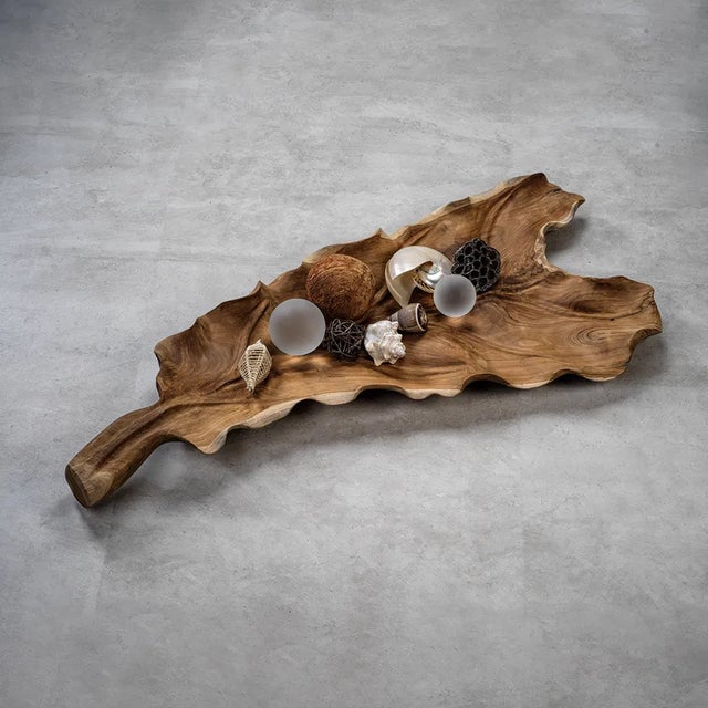 Nature goes luxe in this leaf-shaped catch all crafted of teak root. Dramatically sized, just like the leaf that inspired...