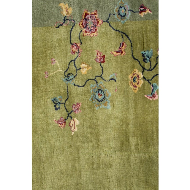 Hand-knotted in wool, this 5x5 contemporary Chinese Deco square rug presents an olive-green center bordered in soft sage,...