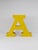 A beautiful and decorative large vintage tin channel letter “A” made of sheet metal, painted in a vibrant yellow with red...