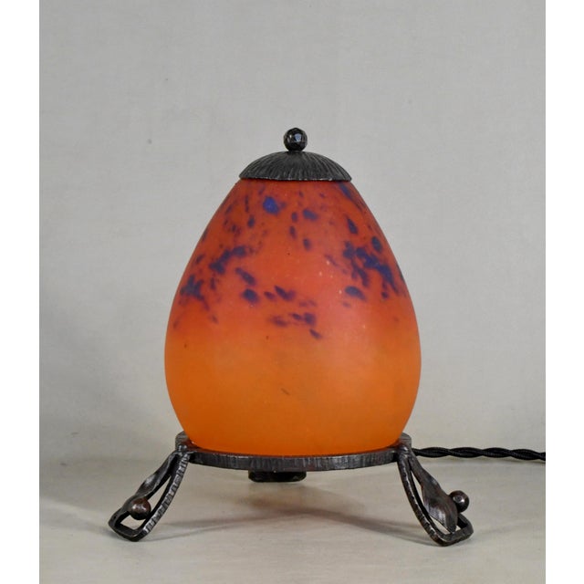 Schneider An adorable French art deco lamp in wrought iron made around 1925-1930. It holds a beautiful coloured shade in...