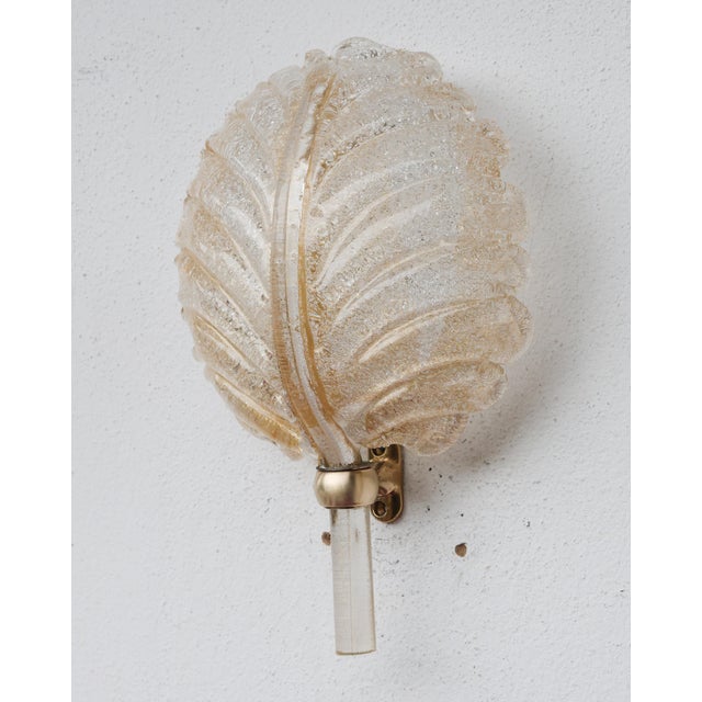 Elegant Italian wall light attributed to Barovier & Toso, produced in the 1960s. Featuring a beautifully textured Murano...