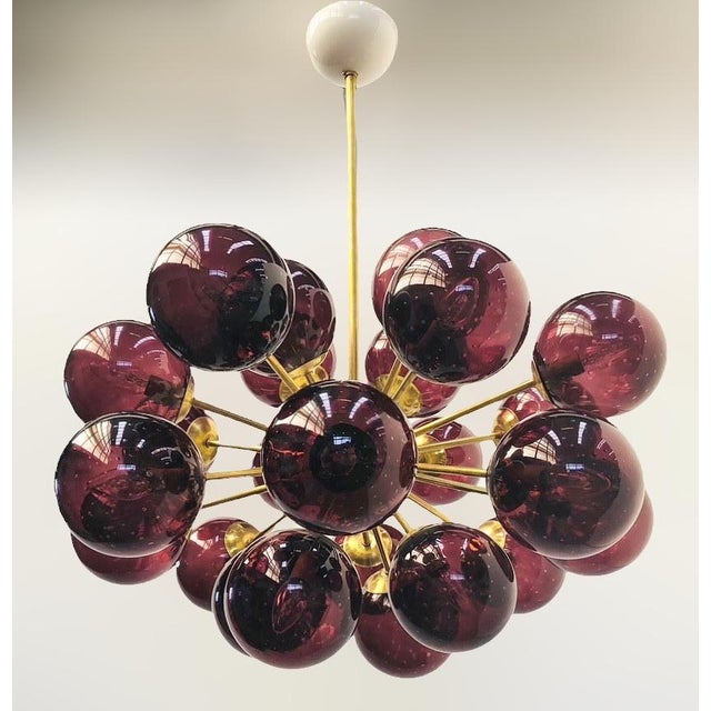 Italian oval shaped sputnik chandelier with 24 amethyst Murano glass globes carefully hand blown with bubbles inside the...