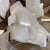 A natural quartz crystal from Uruguay that is presented on a custom gold toned metal stand. Quartz crystals have been...
