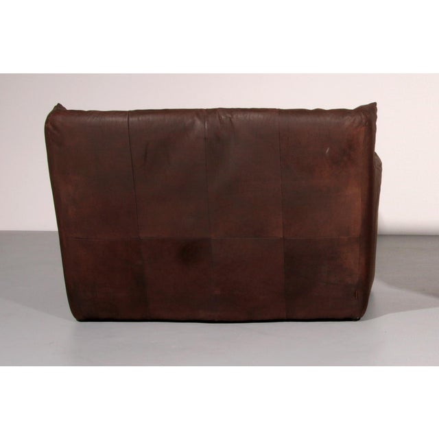 Discover the perfect blend of luxury and comfort with this vintage leather two-seater sofa, designed by the renowned...
