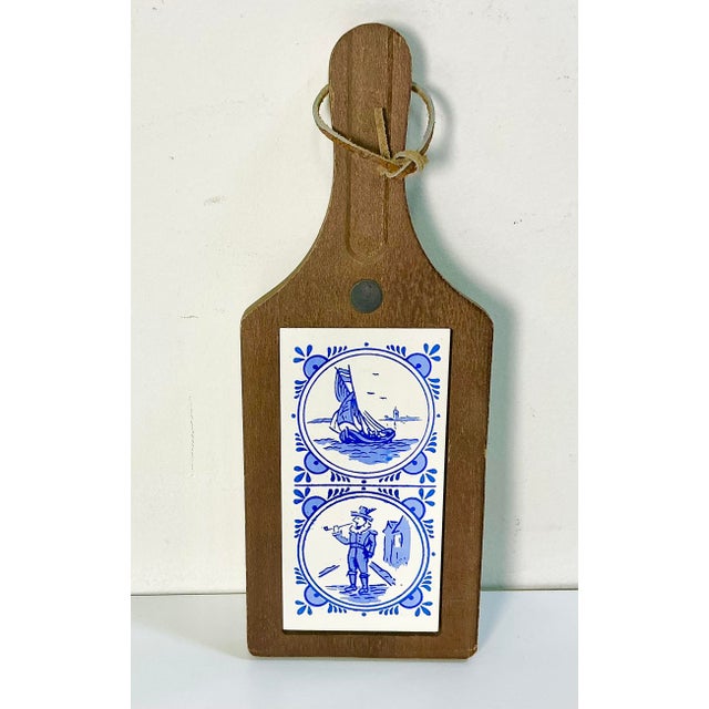 A pretty wood and tile trivet that has a leather strap to hang when not in use. It features a large hand-painted ceramic...