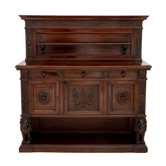 Renaissance Revival Carved Walnut Sideboard, the backboard with single open shelf and carved foliate motif above three...