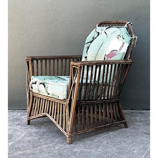 Embrace the timeless glamour of the "California Look" with this exceptional vintage stick rattan lounge chair. Drawing...