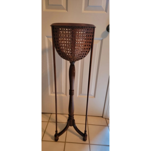 Charming Italian wicker vintage cane plant stand with metal lining. Features tripod base/legs and lovely caned round...