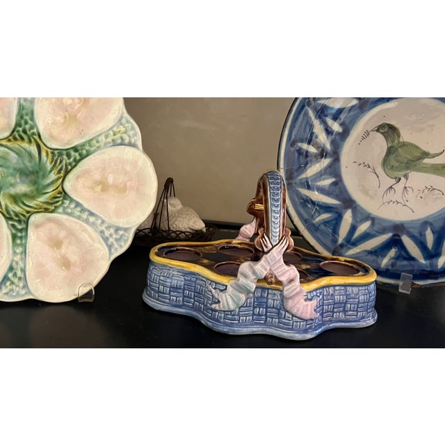 French majolica ceramic basket with bows on the side. The basket made in the 19th century is made to hold soft boiled...