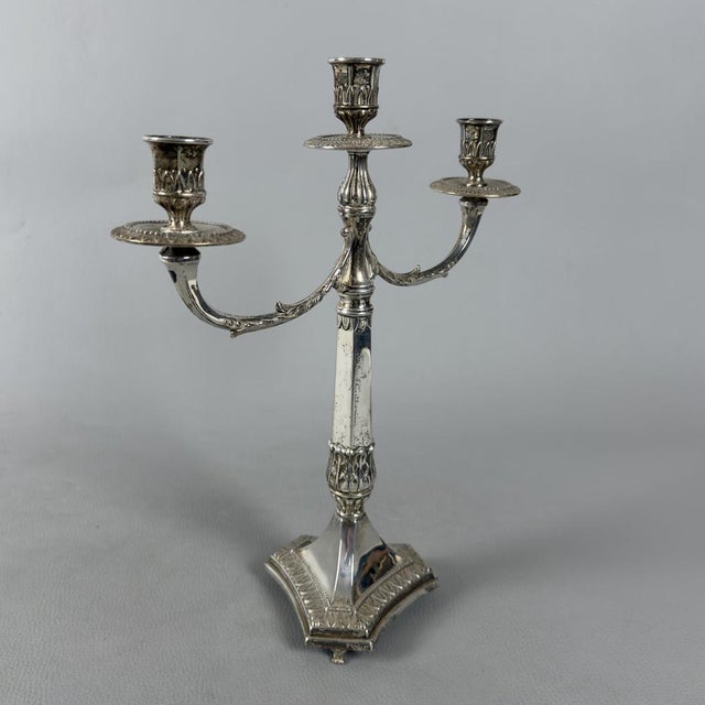 An exquisite three-light candelabra, a true jewel of 20th-century silverware. It stands out for its exceptional...