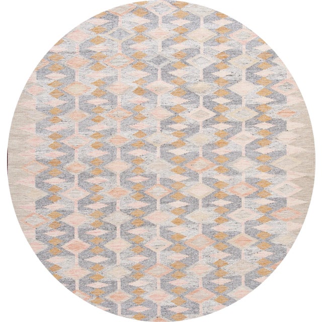 Beautiful 21st-Century Modern Swedish hand-knotted wool rug with a gray field, beige frame. Accents of peach, orange and...