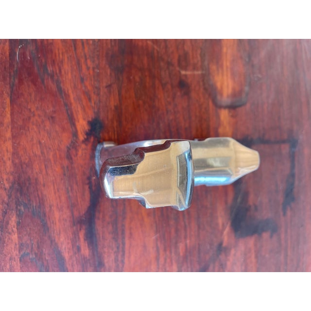 Bring a touch of Art Deco-inspired elegance to your space with this polished aluminum dog sculpture. Featuring bold...