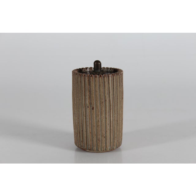 Cylinder shaped lidded jar no. 117 in grooved style by the Danish ceramist Arne Bang (1901-1983) Made at his own studio of...