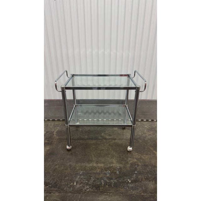 Elevate your hosting game with this quintessential 1970s Space Age bar cart. Featuring a brilliant polished chrome frame...