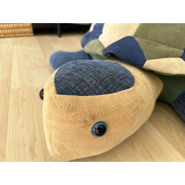 This large leather pouf, crafted in the shape of a turtle, is a charming vintage piece from the 1970s. It features a...