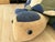 This large leather pouf, crafted in the shape of a turtle, is a charming vintage piece from the 1970s. It features a...