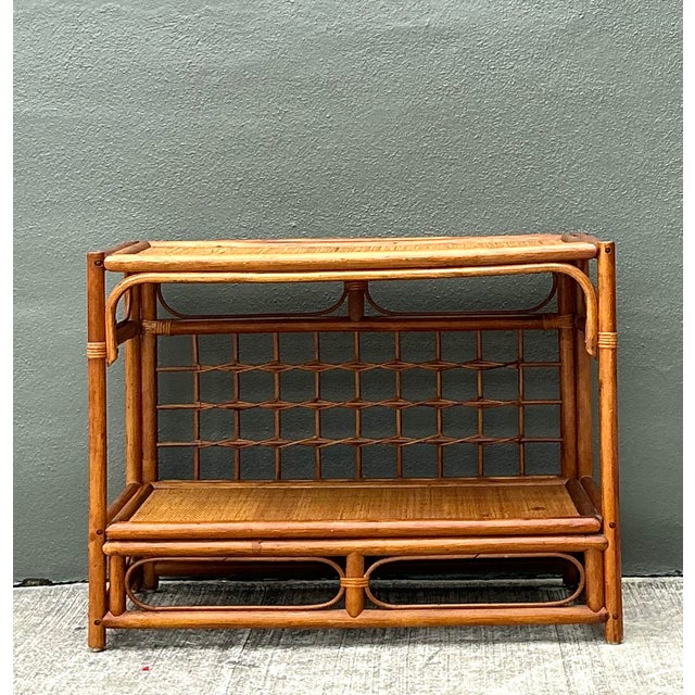 This vintage rattan sideboard is a stunning example of mid-century coastal elegance, featuring a distinctive open-grid...