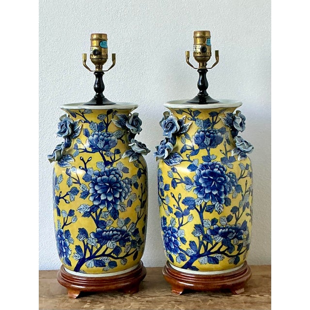 This exquisite pair of vintage Chinoiserie table lamps is a vibrant celebration of mid-century artisanal craft and...