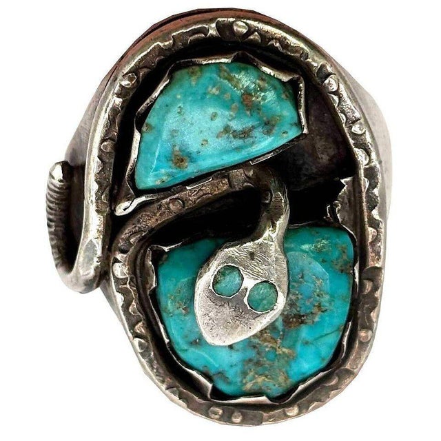 Effie Calavaza's original men's size 10 snake ring features a striking combination of turquoise and silver. Crafted with...