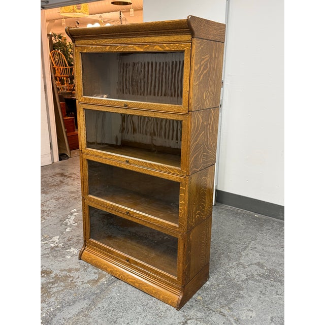 Design Plus Gallery presents a Vintage Oak Barrister Bookcase. This stackable bookcase showcases quarter-sawn oak grain,...