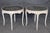 An exquisite and highly decorative pair of French Louis XV-style painted and gilded marble-top side tables, dating to the...
