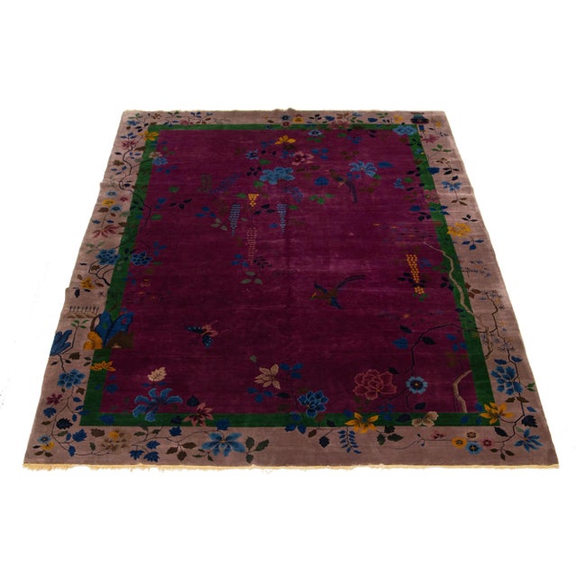 This hand-knotted wool Antique Chinese Art Deco rug features a floral design with multicolored hues on a purple background...