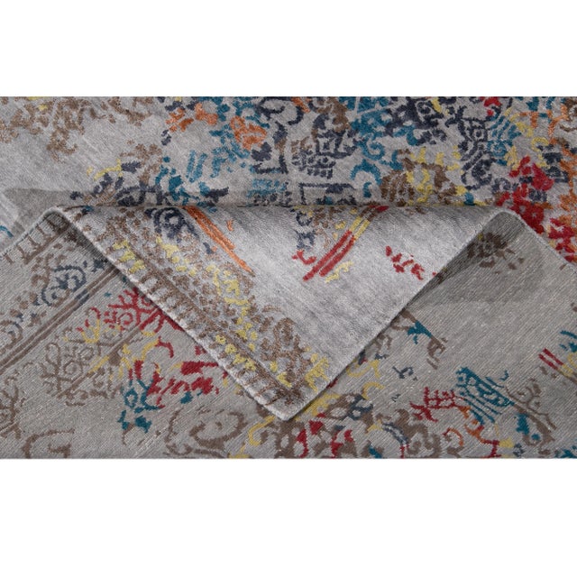 Beautiful hand-knotted wool, abstract rug. This rug has a grey field with an all over abstract design with multicolored...