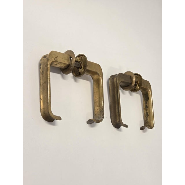 Two pairs of brass door handles designed by Ilmari Tapiovaara. The door handles have the manufacturer's stamp EXO. In good...