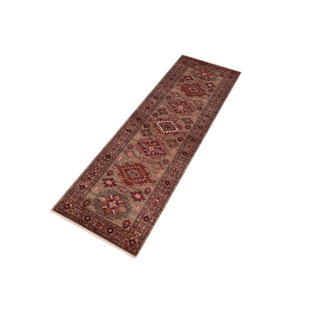 Enhance your home with this exquisite hand-knotted Super Kazak rug, crafted from fine hand-spun wool and dyed with all-...