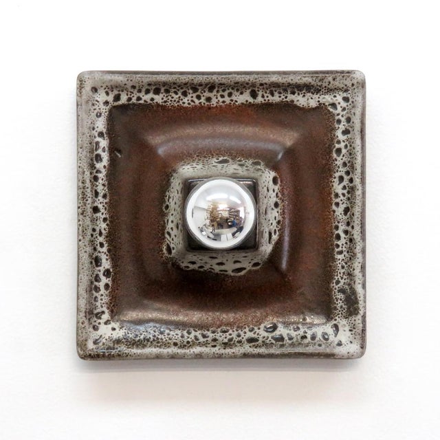 wonderful multi-tone square German ceramic wall sconces from the 1960s. Single bulb wall lights/flush mounts shown with a...
