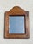 A charming solid wood wall mirror featuring a simple, traditional silhouette enhanced by a gently arched top. Its warm...
