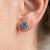 These charming stud earrings feature vibrant Blue Topaz gemstones, admired for their brilliant sky-blue color and...