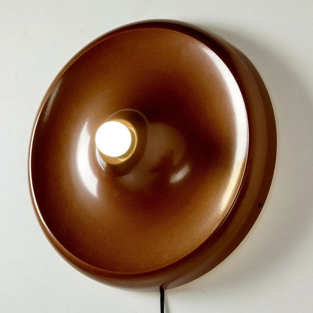 Round metal wall lamp from the 1970s. In addition to its charming light, it can be an exciting element of any space. It...