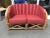 1930s Art Deco sectional two seat rattan sofa features a red shell back seat around the perimeter of the backrest and X...