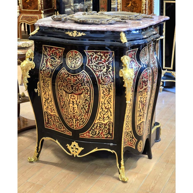 A striking statement piece inspired by the grandeur of French Louis XV furniture, this cabinet combines a dramatic glossy...