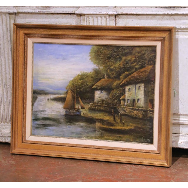 This serene antique landscape painting depicts a quiet riverside village scene, centered on a calm waterway animated by...