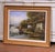 This serene antique landscape painting depicts a quiet riverside village scene, centered on a calm waterway animated by...