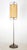 Mid Century Modern floor lamp with an elongated shade with stitching at the ends and a weighted brass finished base. This...