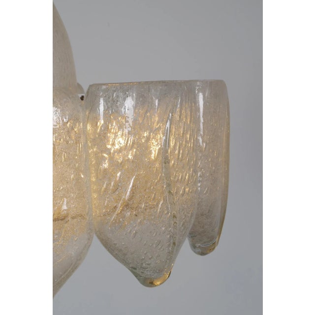 Doria chandelier with 10 pieces of ice glass. This chandelier gives a pleasant surrounding light and also lights...