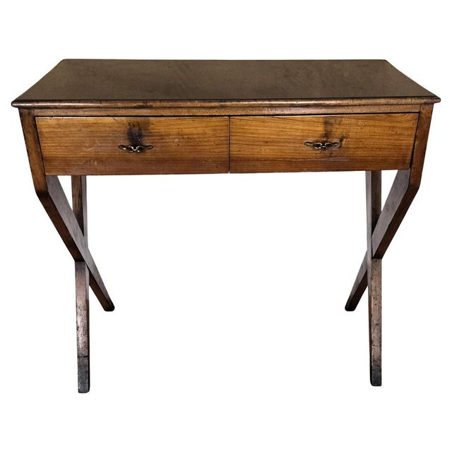 Beautiful Italian Art Deco Mid-Century Modern desk writing table, in wood with elegant carved frame, crossed side legs and...