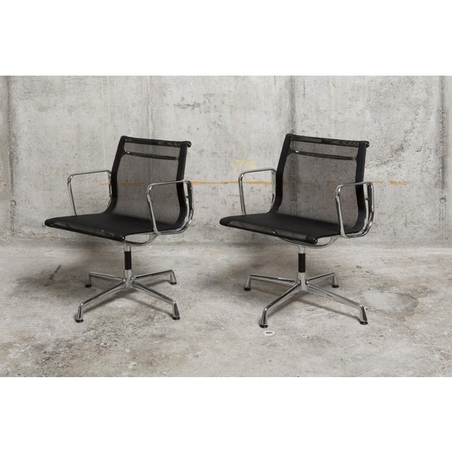 Set of two Eames EA 108 Aluminum Chairs, designed by Charles and Ray Eames and produced by Vitra. The chairs feature the...