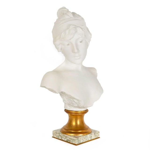 EMMANUEL VILLANIS French, fl. 1880-1920 "Tanagra" Parian porcelain bust over gilt bronze plinth raised on marble base over...