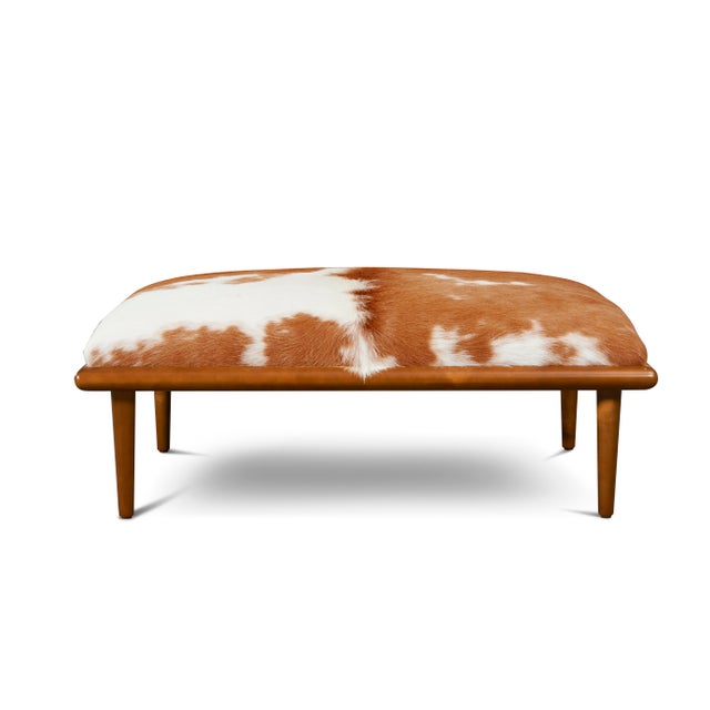 A HANDSOME TRIBUTE: Upholstered with hair on hide, the Caci cocktail ottoman enriches any interior. Its natural...